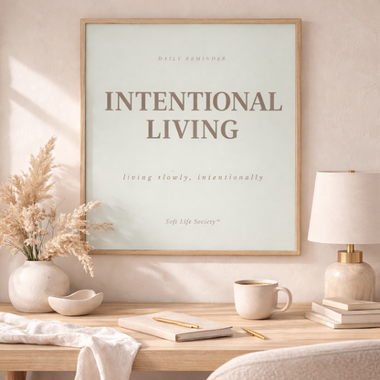 Framed artwork with 'Intentional Living' on a desk with decor items.