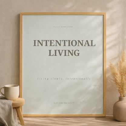 Framed poster with 'Intentional Living' text on a wall with decor elements.