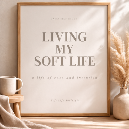 Framed print with 'Living My Soft Life' text on a neutral background with decor items.