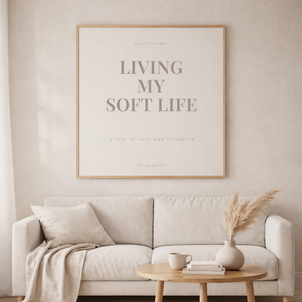Living room with a beige sofa, wooden coffee table, and framed poster on the wall.