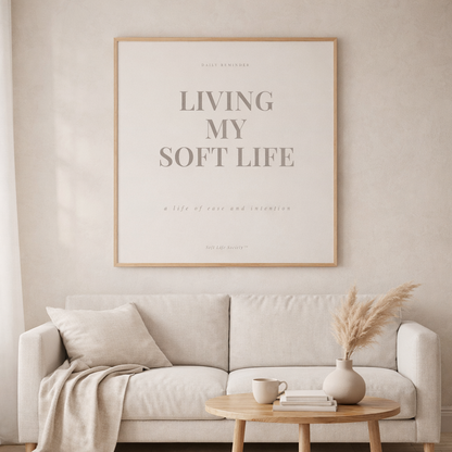 Living room with a beige sofa, wooden coffee table, and framed poster on the wall.