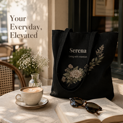Black floral canvas tote bag personalized with name Serena on café table with coffee and sunglasses soft neutral aesthetic