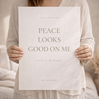 Person holding a paper with text 'PEACE LOOKS GOOD ON ME' and 'calm is my power' in a neutral setting.