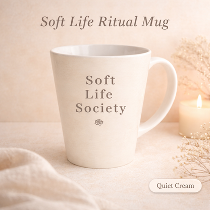 Cream mug with 'Soft Life Society' text on a soft beige background
