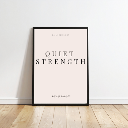 Framed poster with 'Quiet Strength' text on a white wall.