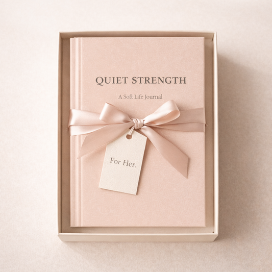 Pink 'Quiet Strength' journal with a bow in a box on a light background