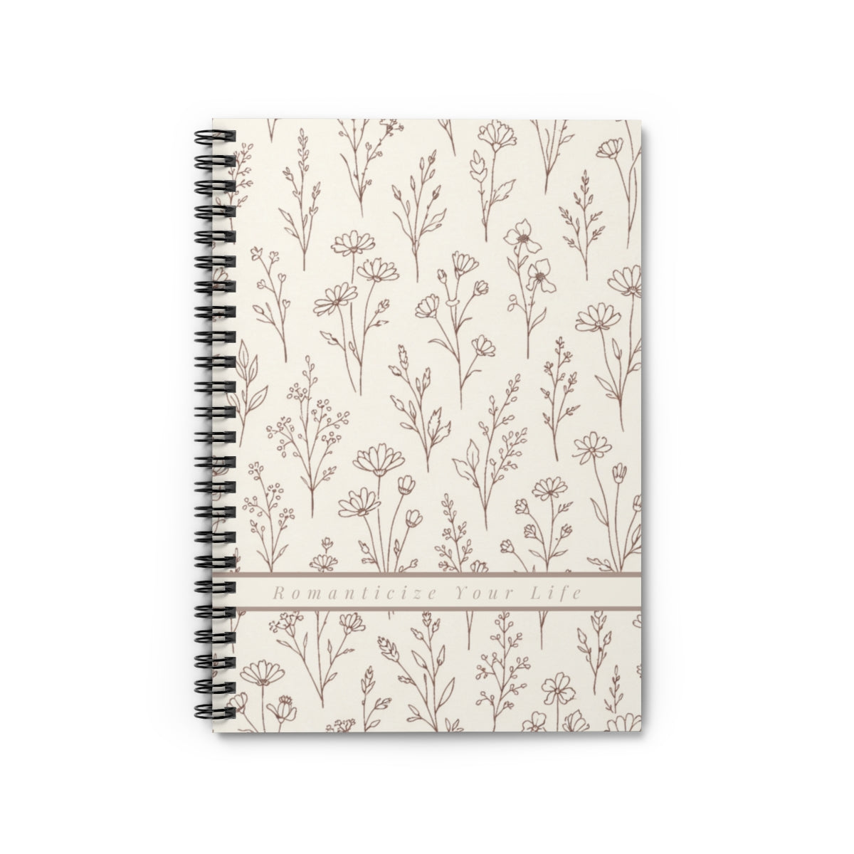 Notebook with floral pattern with banner reading "Romanticize Your Life" affirmation on a white background