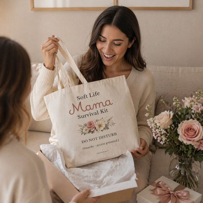 Woman receiving a 'Soft Life Mama Survival Kit' bag as a gift.
