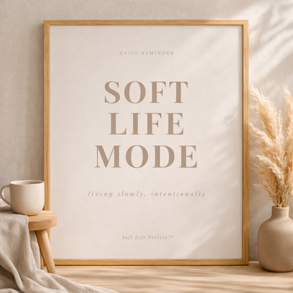 Beige room with 'Soft Life Mode' framed print propped on the wall