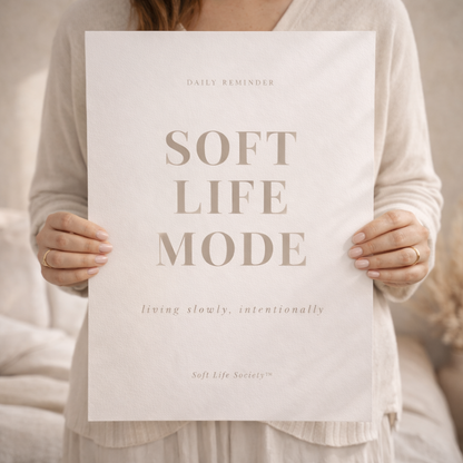 Person holding a sign with 'Soft Life Mode' text in a neutral setting