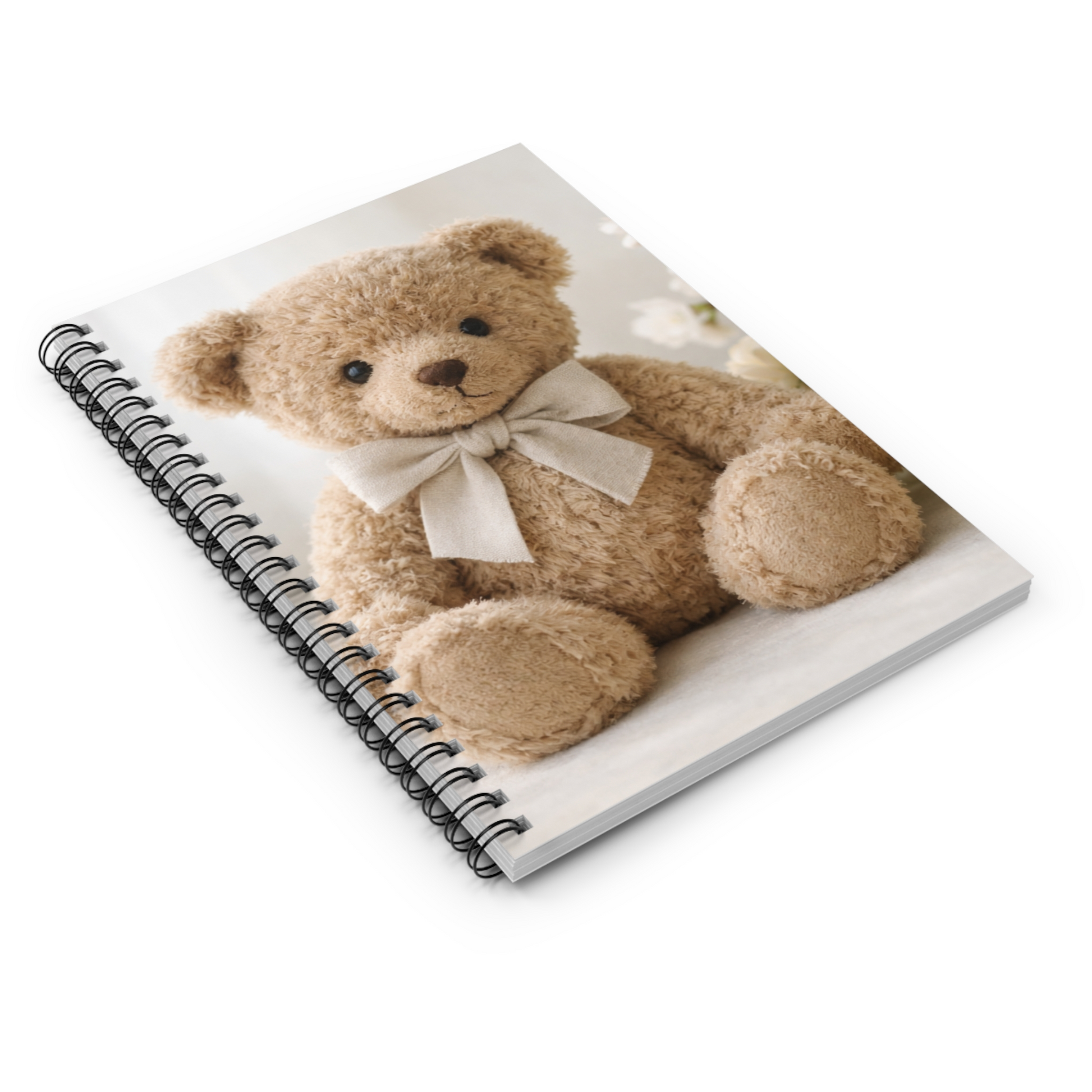 Cozy spiral journal with teddy bear cover photographed at an angle on a white surface