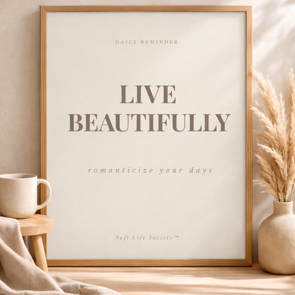 Framed print with 'Live Beautifully' text on a wall with decor elements.