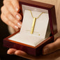 Custom gold bar necklace held in hands inside Soft Life Society™ jewelry box