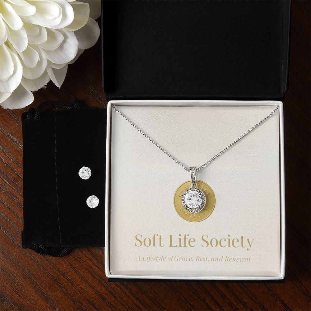 Timeless solitaire pendant necklace with matching earrings displayed in Soft Life Society deluxe jewelry box.