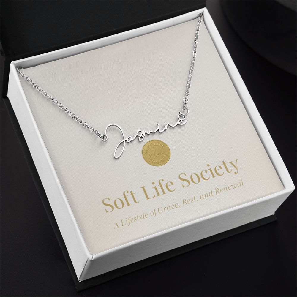 Soft Life Society Signature Style Name Necklace in silver with “Jasmine” pendant displayed in black gift box on gold-accent message card.