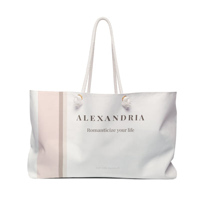 Blush striped cream and blush striped weekender tote bag with rope handles.
