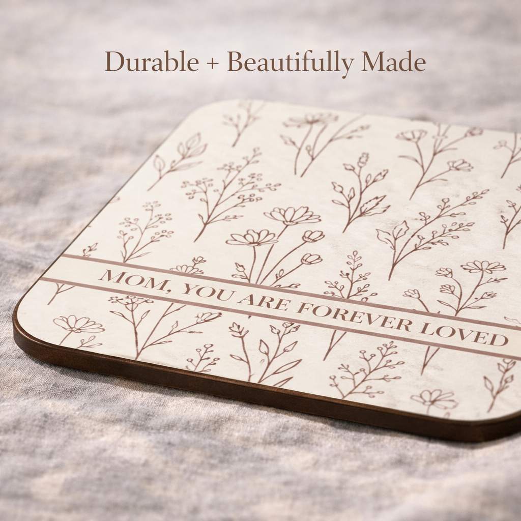 Closeup of view of decorative coaster with floral design and text on a textured surface