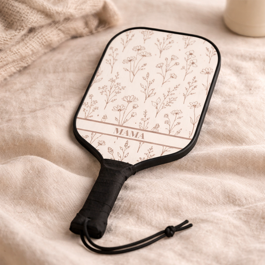 Paddle with floral pattern and 'MAMA' text on a textured surface
