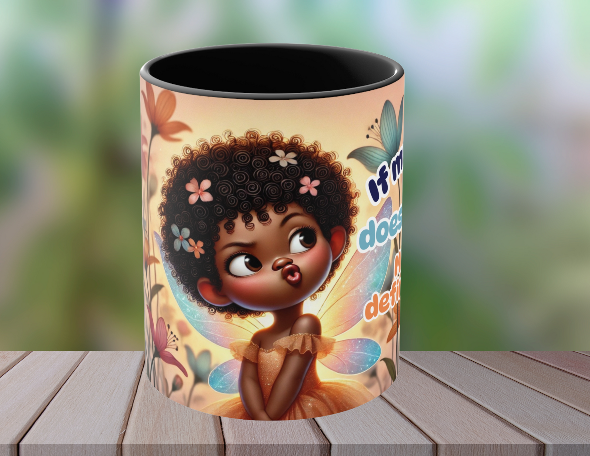 Afro fairy coffee mug with humorous text displayed on a wooden surface with a spoon and macarons
