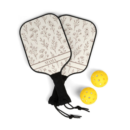 Two pickleball paddles with floral pattern and 'MAMA' text, accompanied by two yellow pickleballs on a white background.