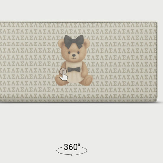 Le Petit Teddy™ Travel Wallet shown from a rotated side angle, highlighting the full-grain Nappa leather exterior and seamless microprint pattern.