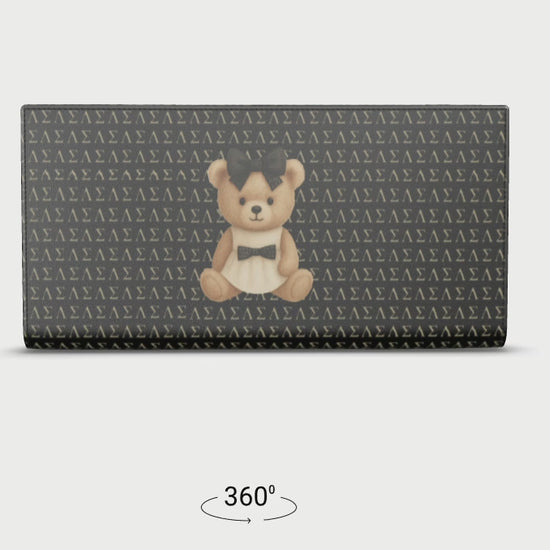 360-degree rotating view of the Le Petit Teddy™ Noir Microprint Wallet, showing the full-grain Nappa leather texture, couture teddy emblem, and repeating Greek-letter monogram from all angles.