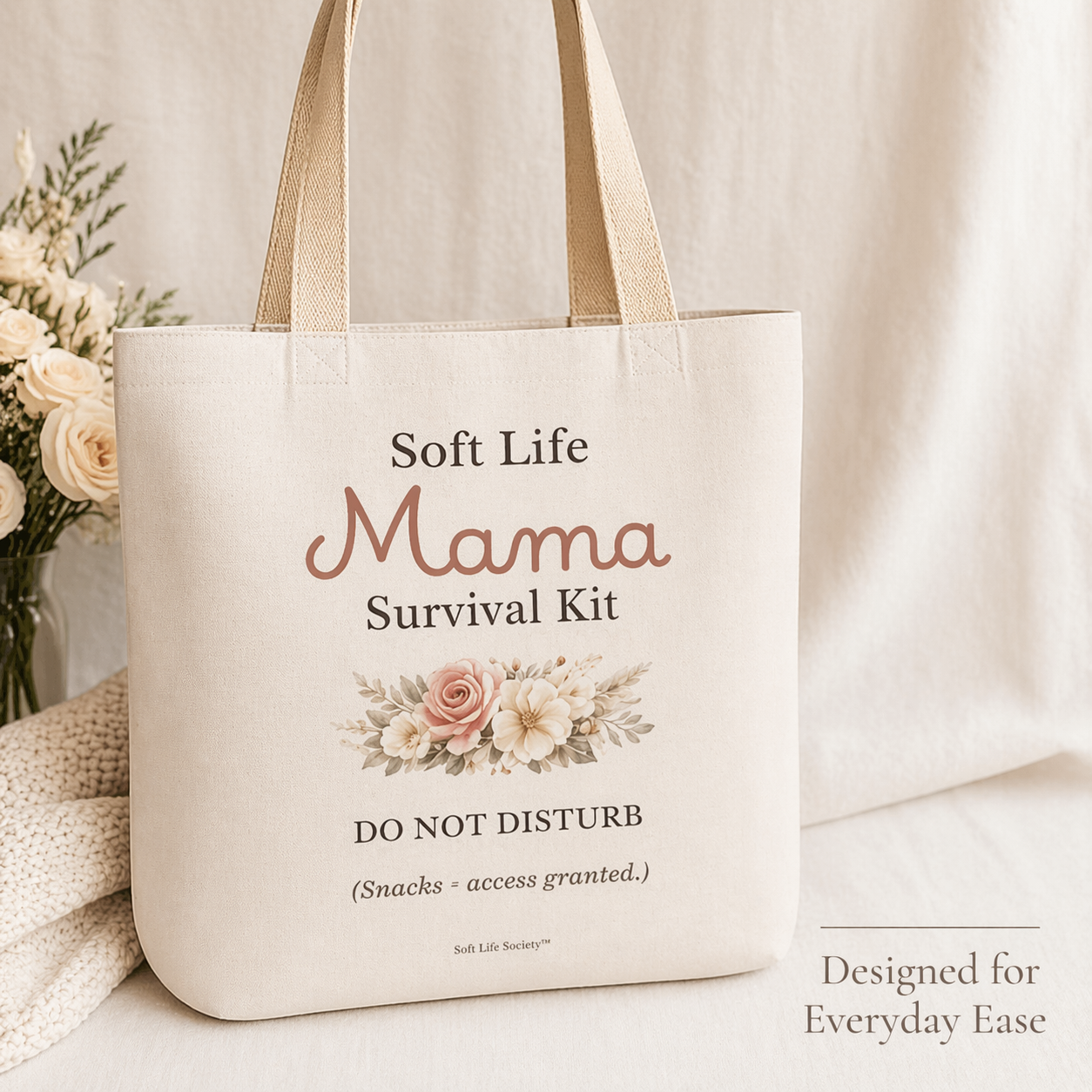 Tote bag with 'Soft Life Mama Survival Kit' text and floral design on a neutral background